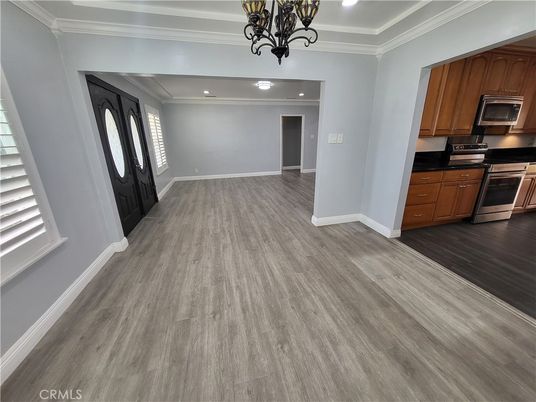 Chandelier, Empty room, Interior, Kitchen, Recessed Lighting, Stainless Steel Appliances, Wood Texture Flooring