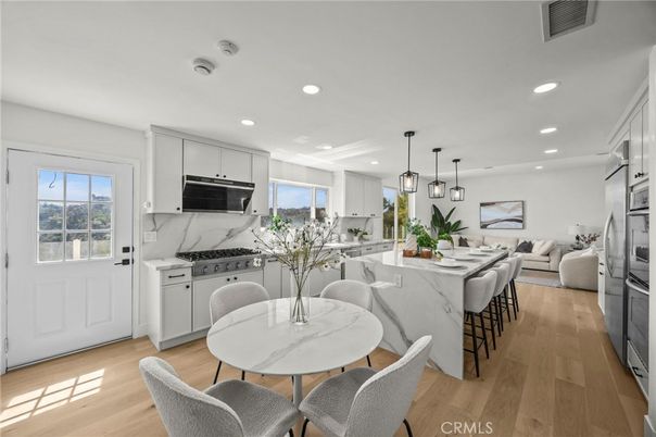 Dining room, Interior, Kitchen, Living room, Marble Walls, Pendant Lights, Recessed Lighting, Stainless Steel Appliances, Wood Texture Flooring