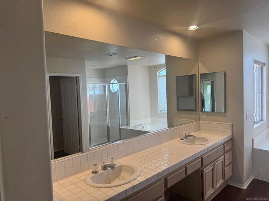 Bathroom, Dual Sink Vanities, Glass Shower, Interior, Recessed Lighting, Tile Countertops, Wood Texture Flooring