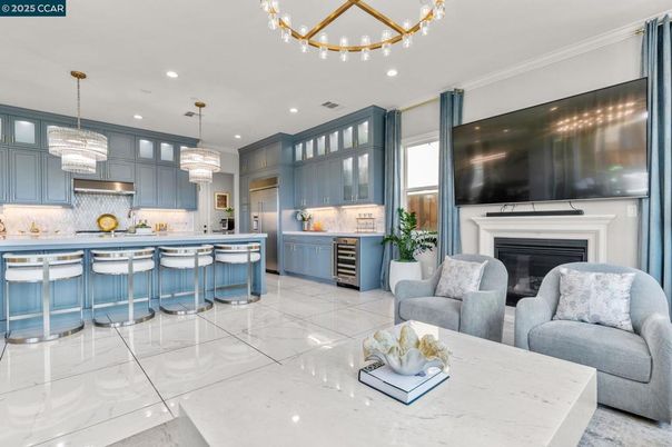 Chandelier, Fireplace, Interior, Kitchen, Living room, Marble, Pendant Lights, Recessed Lighting, Stainless Steel Appliances