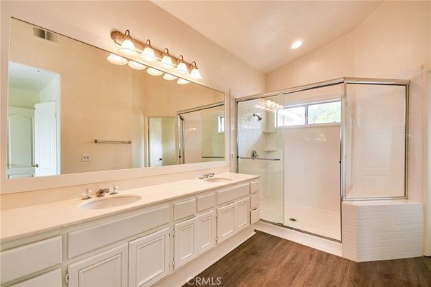 Bathroom, Dual Sink Vanities, Glass Shower, Interior, Recessed Lighting, Wood Texture Flooring