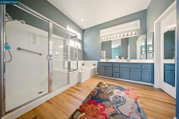 Bathroom, Dual Sink Vanities, Glass Shower, Interior, Recessed Lighting, Wood Texture Flooring