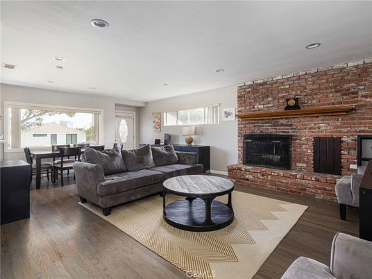 Dining room, Fireplace, Interior, Living room, Recessed Lighting, Stone Walls, Wood Texture Flooring