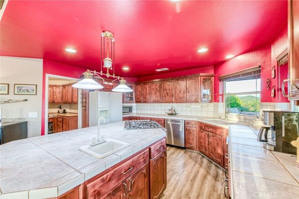 Interior, Kitchen, Pendant Lights, Recessed Lighting, Stainless Steel Appliances, Tile Countertops, Wood Texture Flooring