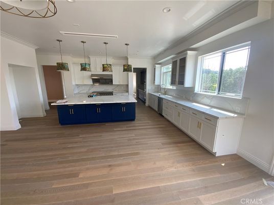 Interior, Kitchen, Marble Walls, Pendant Lights, Recessed Lighting, Stainless Steel Appliances, Wood Texture Flooring