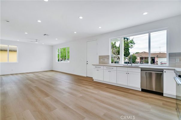 Empty room, Interior, Kitchen, Recessed Lighting, Stainless Steel Appliances, Wood Texture Flooring