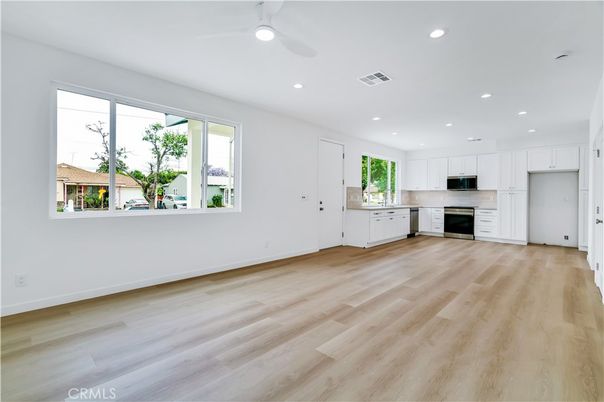 Empty room, Interior, Kitchen, Recessed Lighting, Stainless Steel Appliances, Wood Texture Flooring