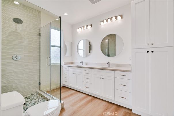 Bathroom, Dual Sink Vanities, Glass Shower, Interior, Recessed Lighting, Wood Texture Flooring