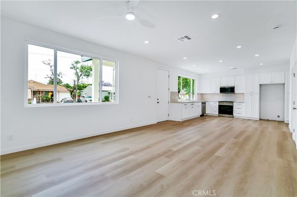 Empty room, Interior, Kitchen, Recessed Lighting, Stainless Steel Appliances, Wood Texture Flooring