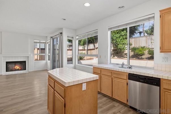 Fireplace, Interior, Kitchen, Recessed Lighting, Stainless Steel Appliances, Tile Countertops, Wood Texture Flooring