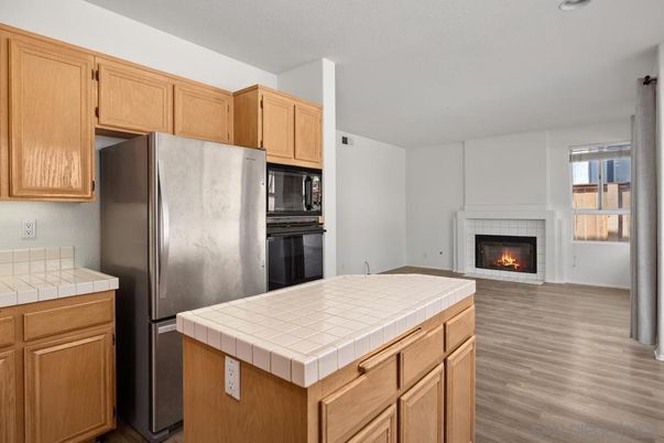 Fireplace, Interior, Kitchen, Tile Countertops, Wood Texture Flooring