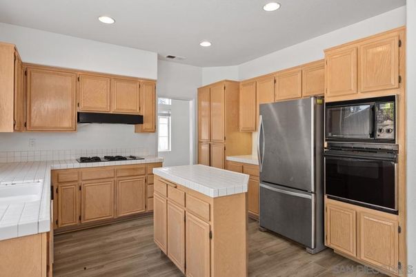 Interior, Kitchen, Recessed Lighting, Tile Countertops, Wood Texture Flooring