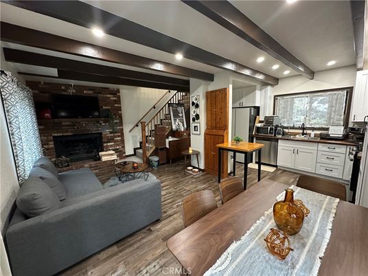 Dining room, Fireplace, Interior, Kitchen, Living room, Recessed Lighting, Stone Walls, Wood Texture Flooring
