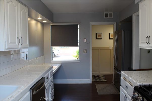 Interior, Kitchen, Recessed Lighting, Tile Countertops, Wood Texture Flooring