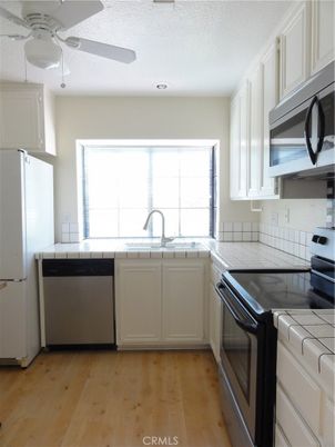 Interior, Kitchen, Recessed Lighting, Tile Countertops, Wood Texture Flooring