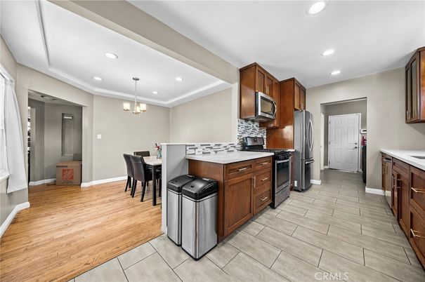 Chandelier, Dining room, Interior, Kitchen, Pendant Lights, Recessed Lighting, Stainless Steel Appliances, Wood Texture Flooring