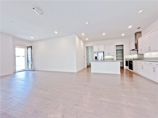 Empty room, Interior, Kitchen, Recessed Lighting, Stainless Steel Appliances, Wood Texture Flooring