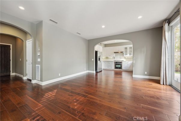 Empty room, Interior, Kitchen, Recessed Lighting, Stainless Steel Appliances, Wood Texture Flooring