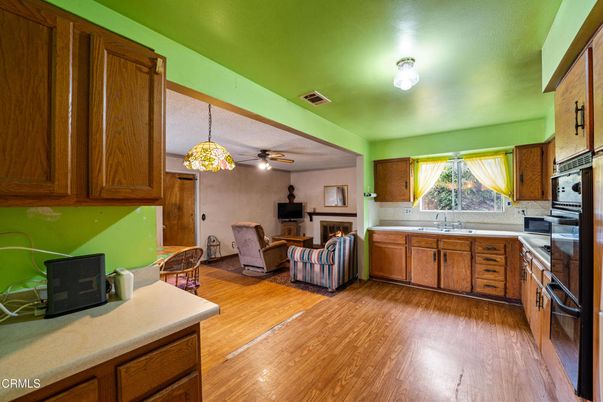 Dining room, Fireplace, Interior, Kitchen, Pendant Lights, Stainless Steel Appliances, Wood Texture Flooring