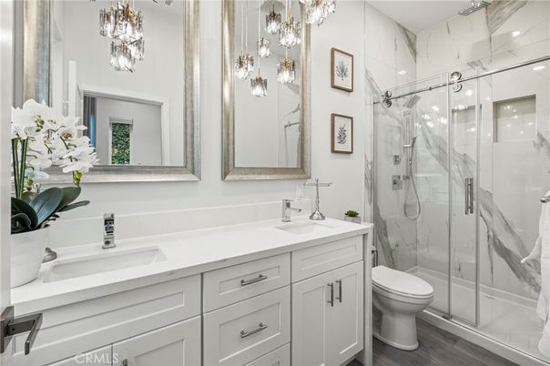 Bathroom, Dual Sink Vanities, Glass Shower, Interior, Marble Walls, Wood Texture Flooring