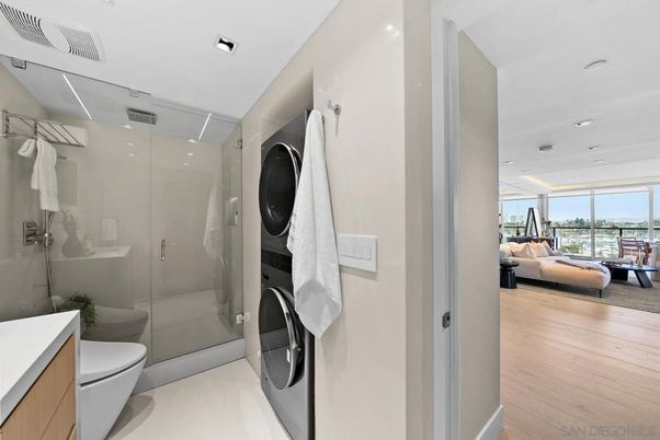 Bathroom, Glass Shower, Interior, Recessed Lighting, Washer, Wood Texture Flooring