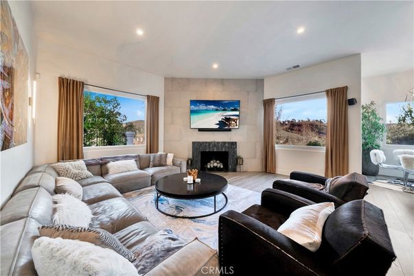 Fireplace, Interior, Living room, Recessed Lighting, Stone Walls, Wood Texture Flooring