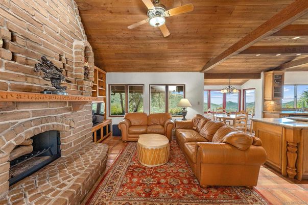 Chandelier, Dining room, Fireplace, Interior, Living room, Recessed Lighting, Stone Walls, Water, Wooden Beams, Wooden Ceilings