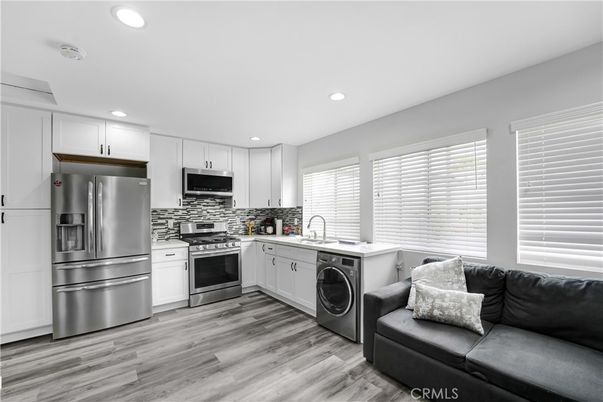 Interior, Kitchen, Recessed Lighting, Stainless Steel Appliances, Washer, Wood Texture Flooring