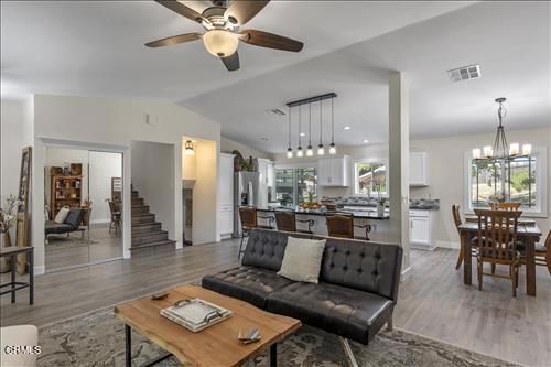 Chandelier, Dining room, Interior, Kitchen, Living room, Pendant Lights, Recessed Lighting, Stainless Steel Appliances, Wood Texture Flooring