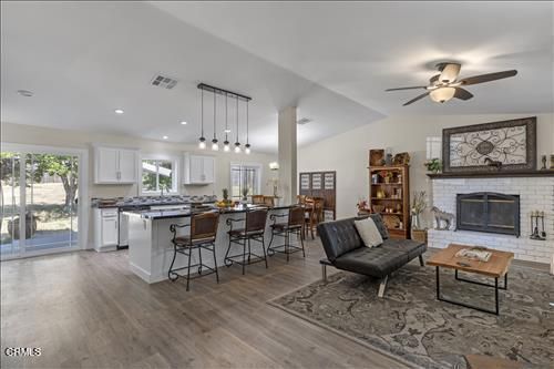Dining room, Fireplace, Interior, Kitchen, Living room, Pendant Lights, Recessed Lighting, Stainless Steel Appliances, Stone Walls, Wood Texture Flooring