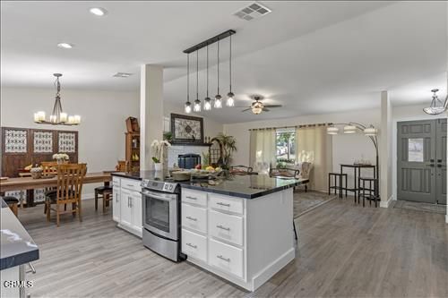 Chandelier, Dining room, Interior, Kitchen, Pendant Lights, Recessed Lighting, Stainless Steel Appliances, Wood Texture Flooring