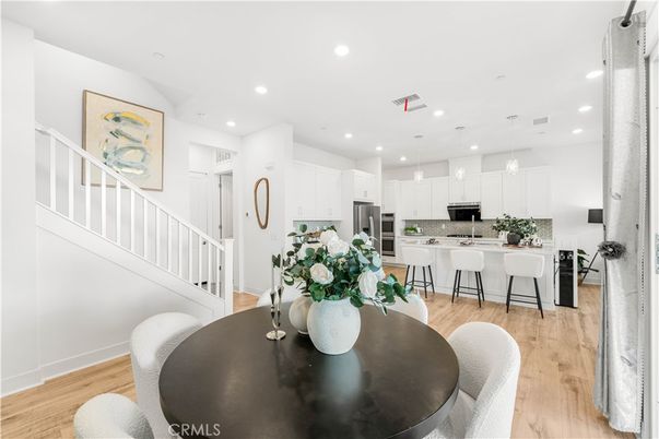 Dining room, Interior, Kitchen, Pendant Lights, Recessed Lighting, Stainless Steel Appliances, Wood Texture Flooring