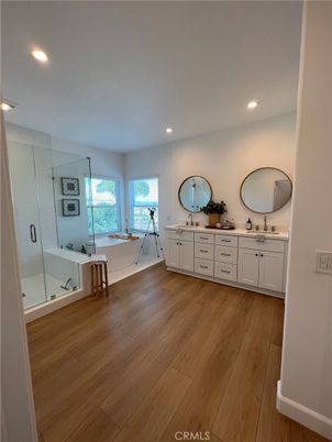 Bathroom, Dual Sink Vanities, Glass Shower, Interior, Recessed Lighting, Wood Texture Flooring