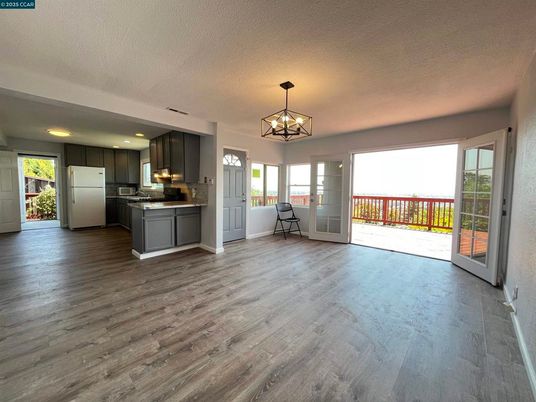 Chandelier, Empty room, Interior, Kitchen, Pendant Lights, Recessed Lighting, Stainless Steel Appliances, Wood Texture Flooring