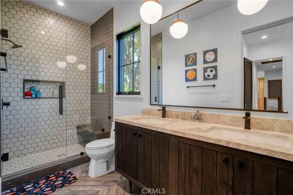 Bathroom, Dual Sink Vanities, Glass Shower, Interior, Pendant Lights, Recessed Lighting, Wood Texture Flooring