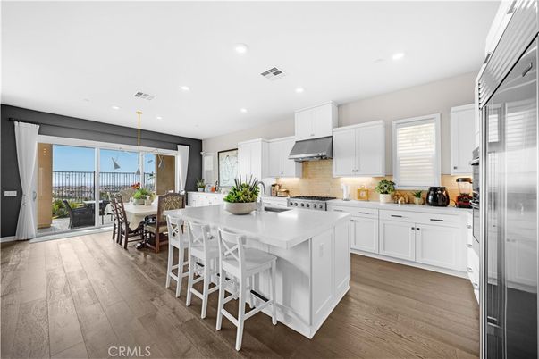 Dining room, Interior, Kitchen, Pendant Lights, Recessed Lighting, Stainless Steel Appliances, Wood Texture Flooring