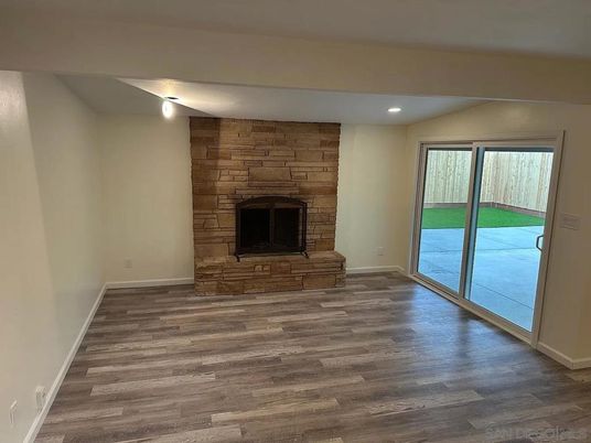 Empty room, Fireplace, Interior, Recessed Lighting, Stone Walls, Wood Texture Flooring
