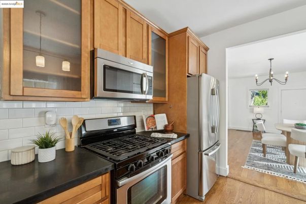 Chandelier, Dining room, Interior, Kitchen, Pendant Lights, Stainless Steel Appliances, Wood Texture Flooring