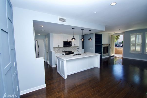 Fireplace, Interior, Kitchen, Pendant Lights, Recessed Lighting, Stainless Steel Appliances, Wood Texture Flooring