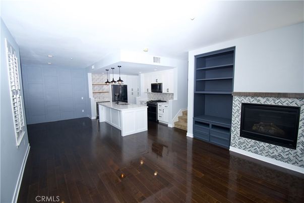 Empty room, Fireplace, Interior, Kitchen, Pendant Lights, Recessed Lighting, Wood Texture Flooring