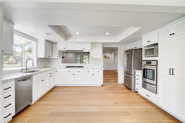 Interior, Kitchen, Marble Walls, Recessed Lighting, Stainless Steel Appliances, Wood Texture Flooring