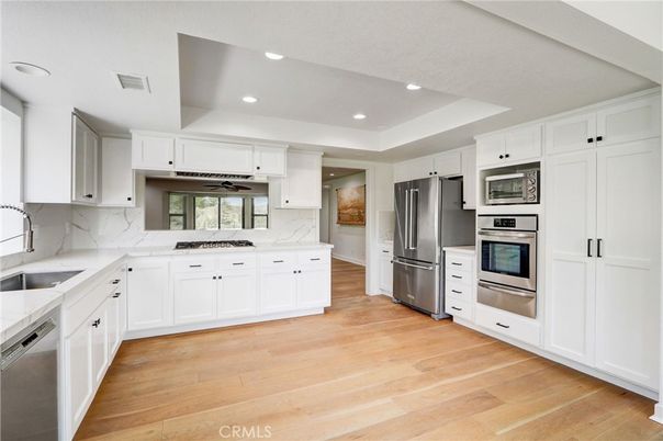 Interior, Kitchen, Marble Walls, Recessed Lighting, Stainless Steel Appliances, Wood Texture Flooring