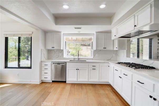 Interior, Kitchen, Marble Walls, Recessed Lighting, Stainless Steel Appliances, Wood Texture Flooring
