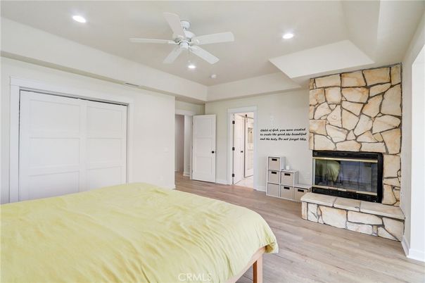 Bedroom, Fireplace, Interior, Recessed Lighting, Stone Walls, Wood Texture Flooring