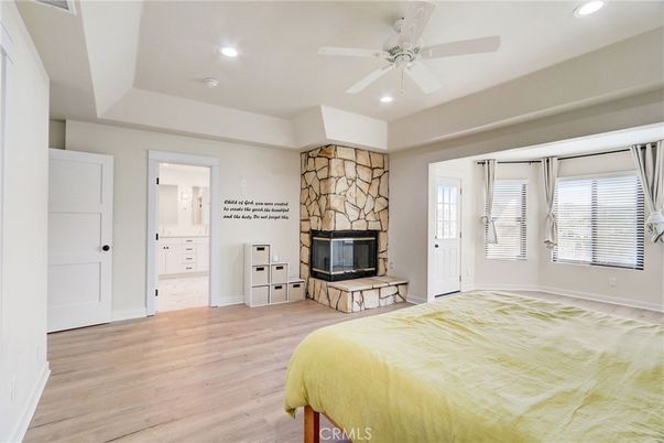 Bedroom, Fireplace, Interior, Recessed Lighting, Stone Walls, Wood Texture Flooring