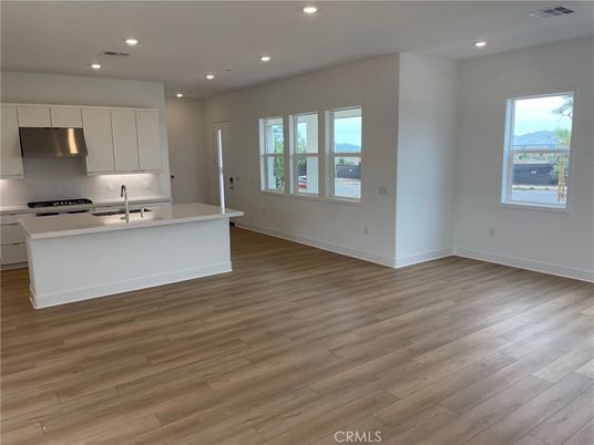 Empty room, Interior, Kitchen, Recessed Lighting, Stainless Steel Appliances, Wood Texture Flooring