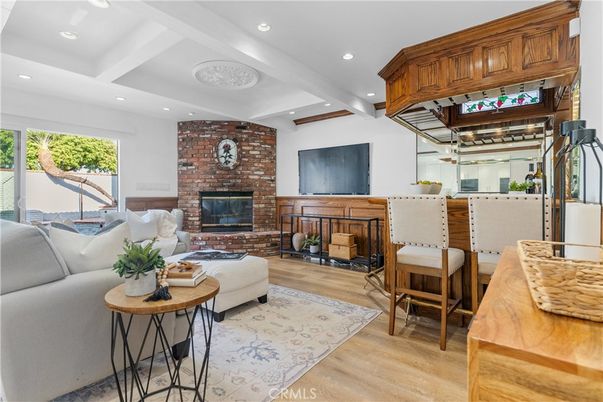 Dining room, Fireplace, Interior, Living room, Recessed Lighting, Stone Walls, Wood Texture Flooring