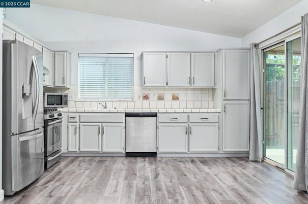 Interior, Kitchen, Recessed Lighting, Stainless Steel Appliances, Tile Countertops, Wood Texture Flooring
