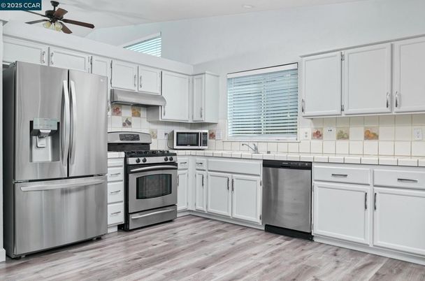 Interior, Kitchen, Stainless Steel Appliances, Tile Countertops, Wood Texture Flooring