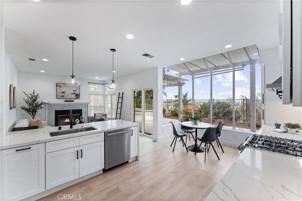Dining room, Fireplace, Interior, Kitchen, Pendant Lights, Recessed Lighting, Stainless Steel Appliances, Wood Texture Flooring